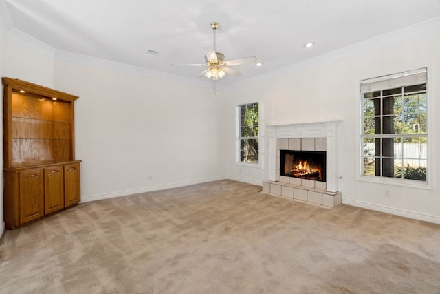 3600 Sawmill Dr, Austin, TX 78749 - unfurnished living room with healthy amount of natural light, crown molding, light colored carpet, a tile fireplace, and recessed lighting