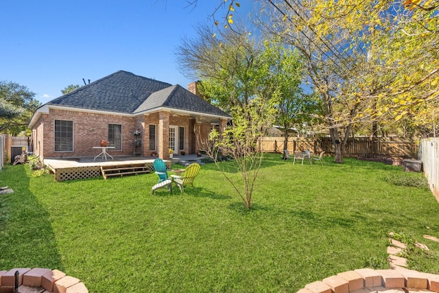 3600 Sawmill Dr, Austin, TX 78749 - rear view of property featuring roof with shingles, a fenced backyard, a deck, a chimney, and brick siding