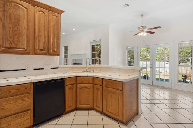 3600 Sawmill Dr, Austin, TX 78749 - kitchen with dishwasher, a peninsula, decorative backsplash, a ceiling fan, and light tile patterned floors