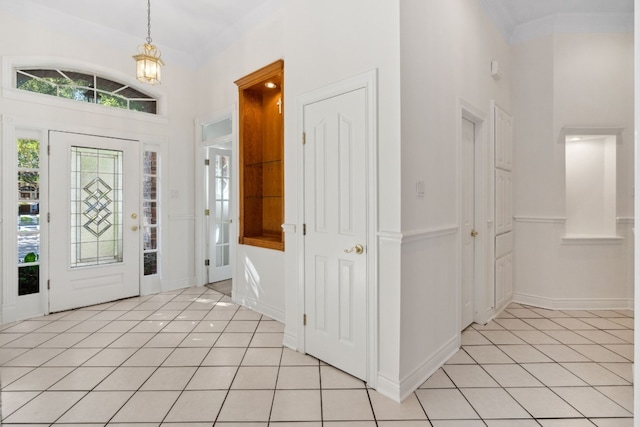 3600 Sawmill Dr, Austin, TX 78749 - entryway with light tile patterned floors, crown molding, a high ceiling, and a chandelier