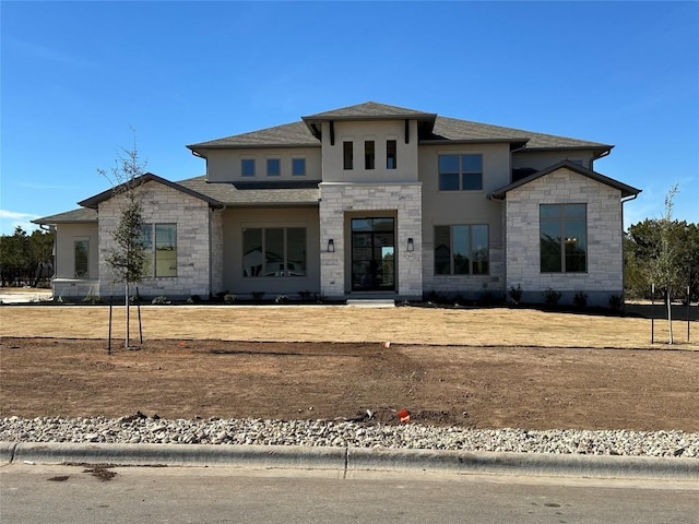 view of front of home with stone siding and stucco siding