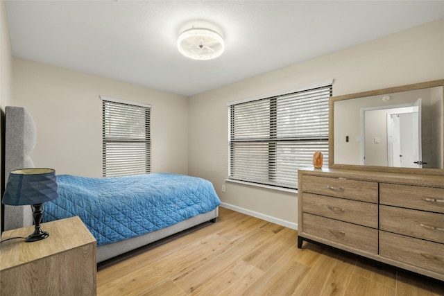 bedroom featuring light hardwood / wood-style floors and multiple windows