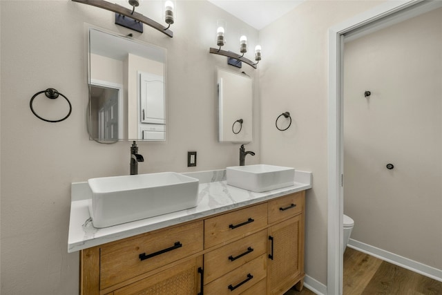 bathroom featuring hardwood / wood-style floors, vanity, and toilet