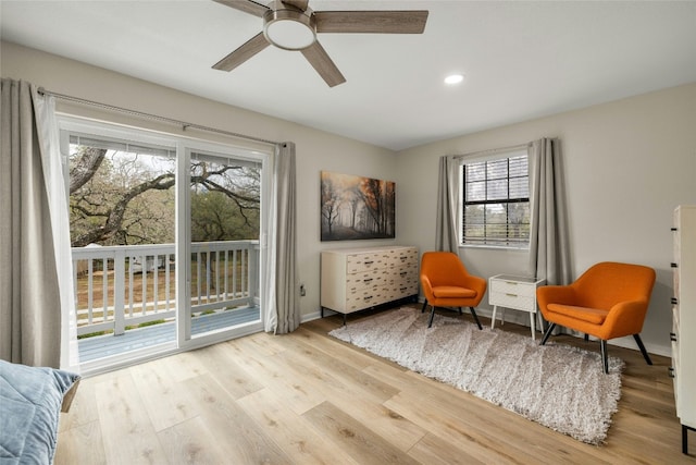 living area featuring ceiling fan, light wood-type flooring, and a wealth of natural light