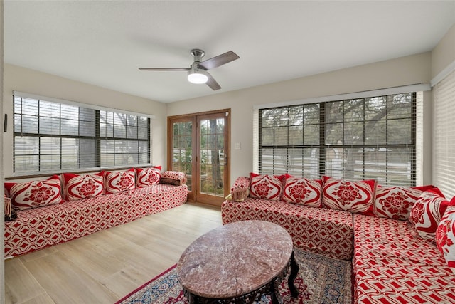 living room featuring hardwood / wood-style flooring and ceiling fan