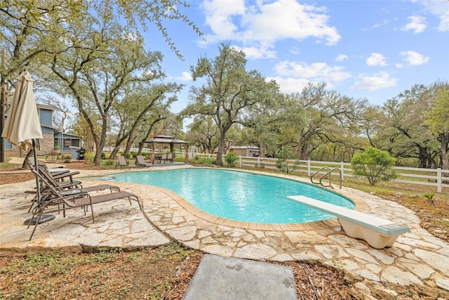 view of pool with a gazebo, a diving board, and a patio area