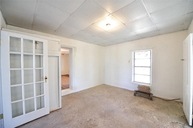 unfurnished room featuring carpet floors and a paneled ceiling