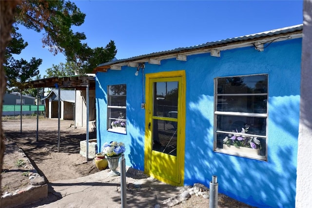 view of side of home with stucco siding