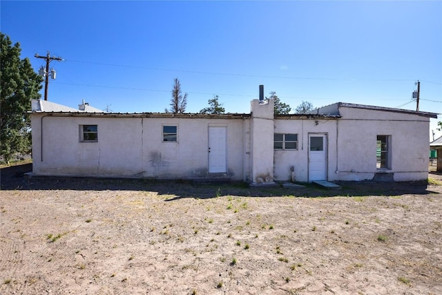 back of house featuring stucco siding