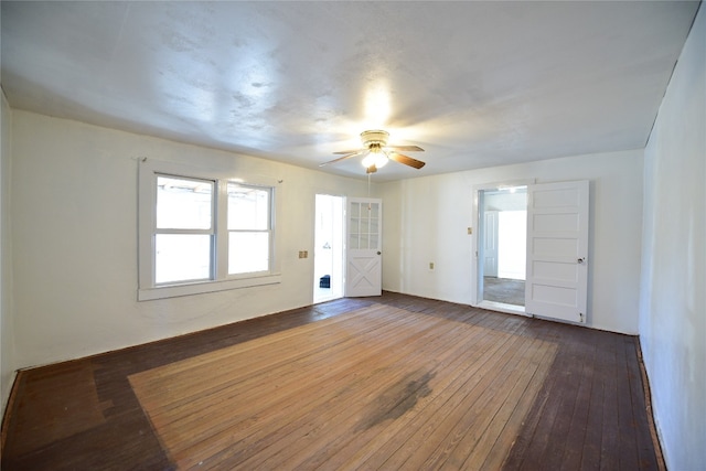 spare room featuring dark wood finished floors and a ceiling fan