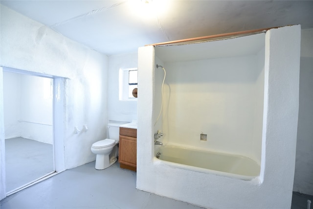 full bath with  shower combination, finished concrete flooring, toilet, and vanity