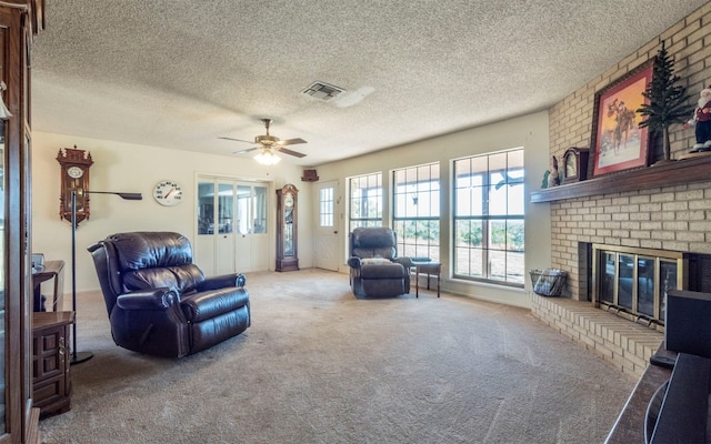 living room featuring carpet flooring, a fireplace, and a textured ceiling