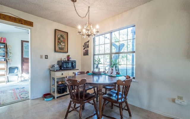 dining room featuring a textured ceiling and a notable chandelier