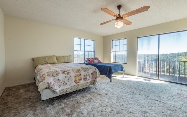 carpeted bedroom with a textured ceiling, access to outside, and ceiling fan