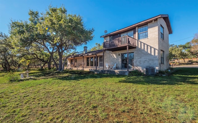 back of house with a balcony, a yard, a patio, and central AC