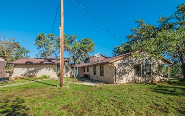 back of house featuring a lawn