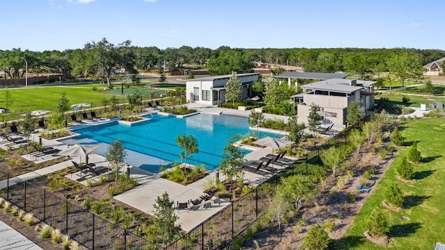 pool with a patio and fence