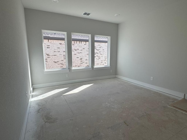 unfurnished room with visible vents and baseboards