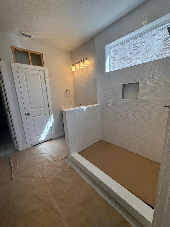 bathroom featuring visible vents and a textured ceiling