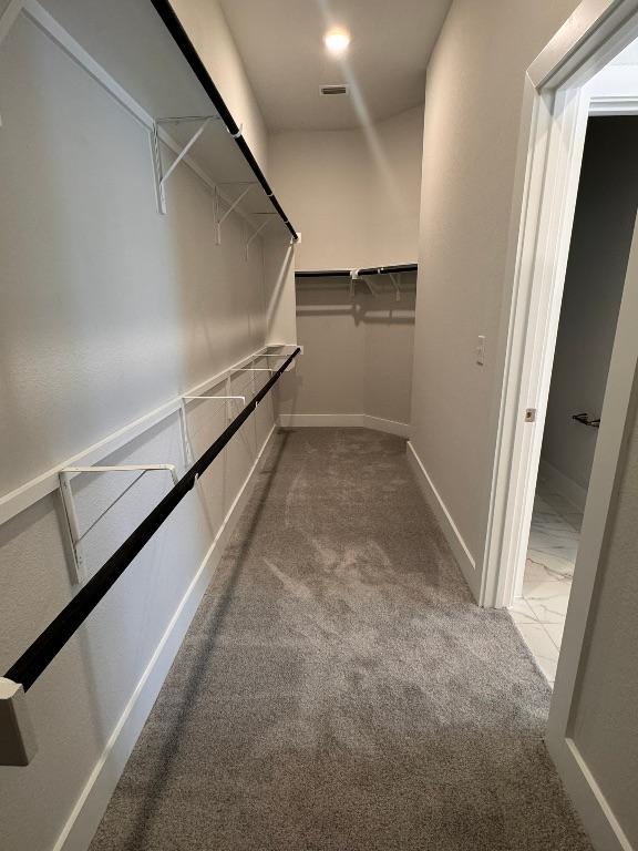 spacious closet with marble finish floor