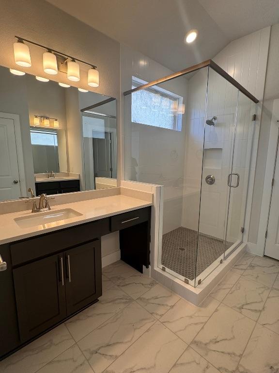 full bathroom featuring recessed lighting, marble finish floor, a stall shower, and vanity