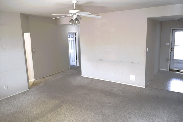 carpeted empty room featuring ceiling fan