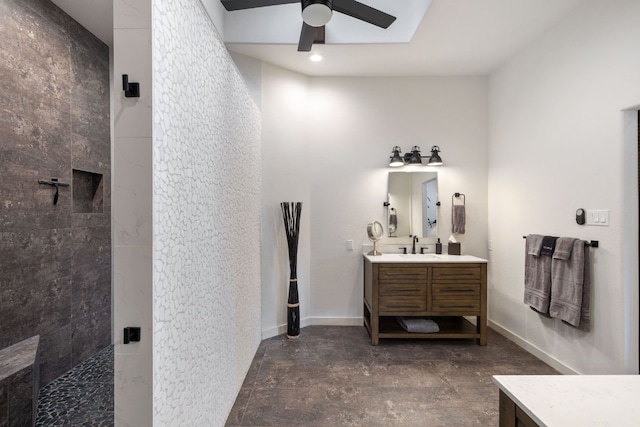 bathroom featuring vanity, ceiling fan, and tiled shower