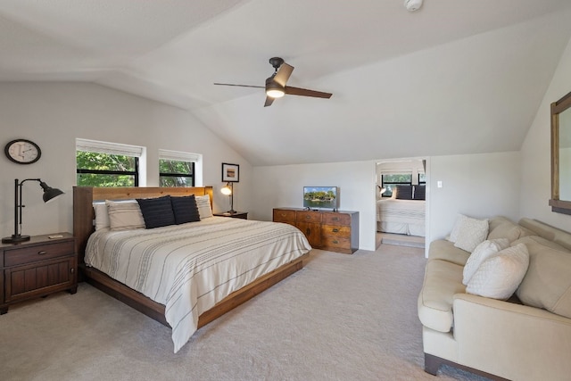 bedroom featuring ceiling fan, light colored carpet, and vaulted ceiling