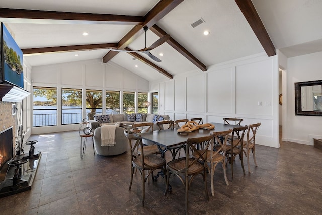 dining space featuring beamed ceiling and high vaulted ceiling