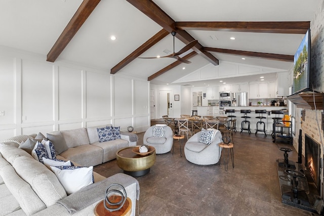 living room with vaulted ceiling with beams and ceiling fan