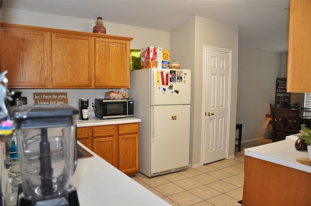 kitchen with white fridge and light tile patterned flooring