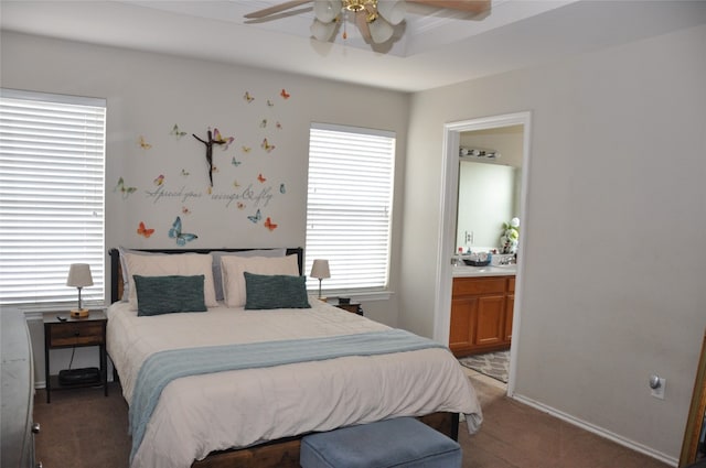 carpeted bedroom with ensuite bathroom and ceiling fan