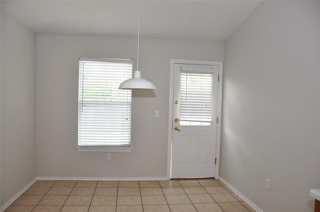 12817 Paloma Blanca Way, Del Valle, TX 78617 - unfurnished dining area featuring plenty of natural light and light tile patterned floors