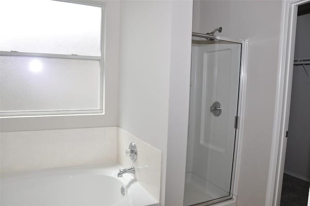12817 Paloma Blanca Way, Del Valle, TX 78617 - bathroom with a stall shower, a bath, and a walk in closet