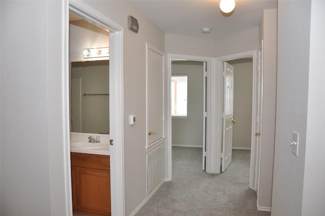 12817 Paloma Blanca Way, Del Valle, TX 78617 - corridor featuring a sink and light colored carpet