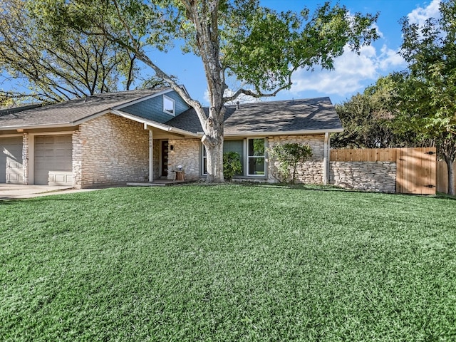 view of front of house with a front yard and a garage