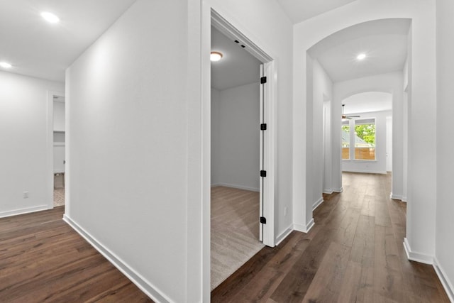 2109 Tobiano Trce, Georgetown, TX 78633 - hall featuring arched walkways, dark wood-style floors, recessed lighting, and baseboards