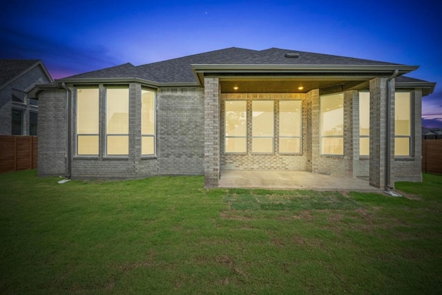 2109 Tobiano Trce, Georgetown, TX 78633 - rear view of house with a patio, brick siding, and roof with shingles