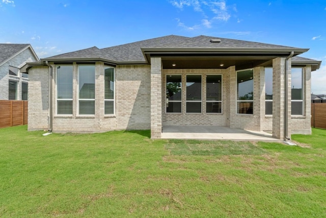 2109 Tobiano Trce, Georgetown, TX 78633 - back of house with a patio area, brick siding, and roof with shingles