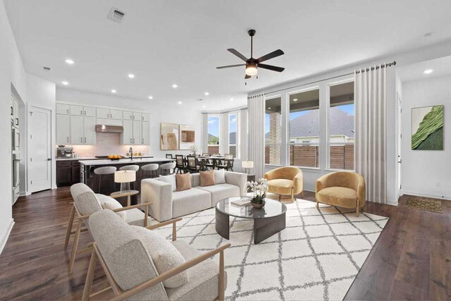 2109 Tobiano Trce, Georgetown, TX 78633 - living room featuring dark wood-style flooring, ceiling fan, recessed lighting, and baseboards