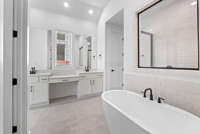 2109 Tobiano Trce, Georgetown, TX 78633 - full bathroom with a freestanding bath, vanity, and recessed lighting