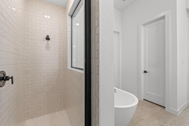 2109 Tobiano Trce, Georgetown, TX 78633 - bathroom featuring a shower stall, a freestanding bath, and tile patterned floors