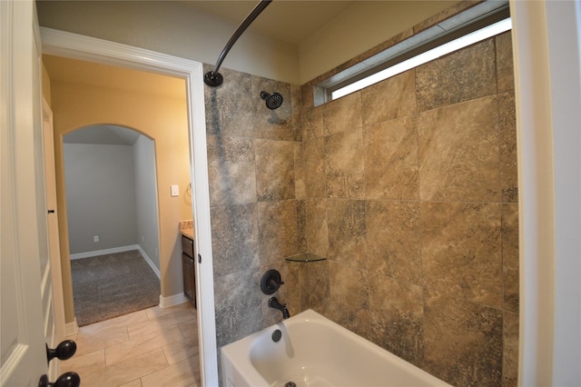 bathroom with tile patterned floors, vanity, and tiled shower / bath