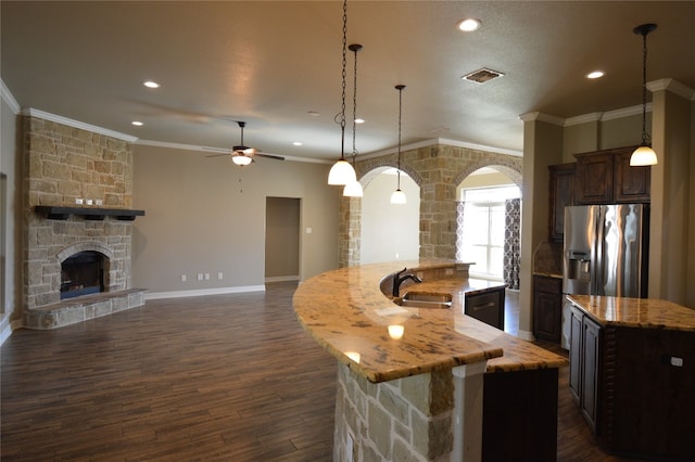 kitchen with pendant lighting, a spacious island, dark hardwood / wood-style floors, and sink