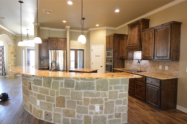 kitchen featuring pendant lighting, dark hardwood / wood-style flooring, a spacious island, and appliances with stainless steel finishes