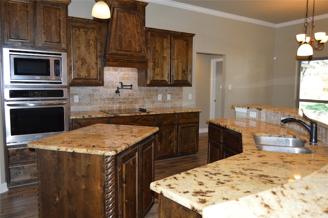 kitchen featuring a center island, stainless steel appliances, an inviting chandelier, and sink