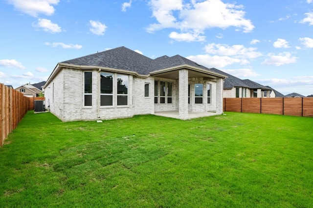 2113 Tobiano Trce, Georgetown, TX 78633 - back of house featuring a patio area, a fenced backyard, brick siding, and a shingled roof