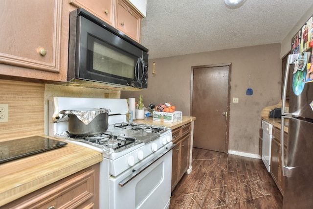 kitchen featuring a textured ceiling and white appliances