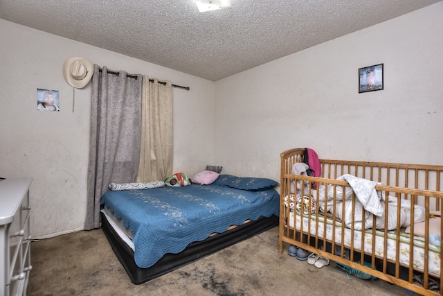 bedroom featuring dark carpet and a textured ceiling