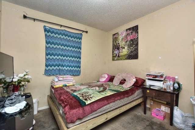 carpeted bedroom featuring a textured ceiling